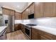 Modern kitchen featuring stainless steel appliances, white countertops, and wood flooring at 160 South Village Ave, Holly Springs, GA 30115