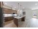 Spacious kitchen with stainless steel appliances, wood cabinets, center island with a sink and white countertops at 160 South Village Ave, Holly Springs, GA 30115