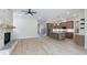 Open-concept living room featuring a stone fireplace and a modern kitchen with an island at 160 South Village Ave, Holly Springs, GA 30115