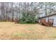 Large backyard with a cozy deck and mature trees, offering a tranquil space for relaxation and outdoor gatherings at 6120 Gwendoline Dr, Atlanta, GA 30349