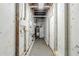 Unfinished basement with visible pipes, water heater, and exposed framework, offering potential for customization at 6120 Gwendoline Dr, Atlanta, GA 30349