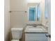Bathroom features a granite countertop vanity with a sink, a mirror, and a toilet at 6120 Gwendoline Dr, Atlanta, GA 30349