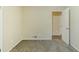 Bedroom showcasing neutral walls, carpet floors, and two doors at 6120 Gwendoline Dr, Atlanta, GA 30349