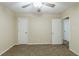 Bedroom featuring neutral walls, carpet floors, a ceiling fan and two doors at 6120 Gwendoline Dr, Atlanta, GA 30349