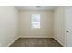 Bedroom showcasing neutral walls, carpet floors, and a window with blinds at 6120 Gwendoline Dr, Atlanta, GA 30349