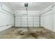 Spacious garage with white walls and an automatic door at 6120 Gwendoline Dr, Atlanta, GA 30349