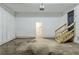 Spacious garage with ample room for parking and storage, featuring a door and stairs to the house at 6120 Gwendoline Dr, Atlanta, GA 30349