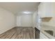 Bright dining area next to kitchen with white cabinets, granite countertops, stainless steel dishwasher, and vinyl flooring at 6120 Gwendoline Dr, Atlanta, GA 30349