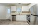 Contemporary kitchen featuring stainless steel appliances, granite countertops, and modern vinyl flooring at 6120 Gwendoline Dr, Atlanta, GA 30349