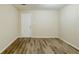 A spare bedroom or office with vinyl flooring, a white door, and plenty of natural light from the window at 6120 Gwendoline Dr, Atlanta, GA 30349