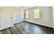 Bedroom featuring wood-look flooring, white trim, and two windows allowing ample natural light at 782 Fox Valley Dr, Stone Mountain, GA 30088