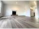 Spacious living room featuring neutral walls, wood-look flooring, and a decorative fireplace at 782 Fox Valley Dr, Stone Mountain, GA 30088