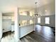 Open-concept living space featuring hardwood floors and stylish lighting fixtures at 782 Fox Valley Dr, Stone Mountain, GA 30088