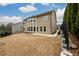 A spacious backyard with a large patio, freshly cut grass, and newly installed black fence at 411 Ridgeway Ln, Canton, GA 30114