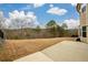 Wide backyard with a concrete patio and serene nature views, perfect for relaxing and outdoor activities at 411 Ridgeway Ln, Canton, GA 30114