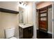 Bathroom featuring a vanity with marble counters, dark cabinets, and a closet organizer at 411 Ridgeway Ln, Canton, GA 30114