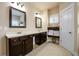 Bathroom featuring double vanity sinks, dark cabinets, and a set of clean white towels at 411 Ridgeway Ln, Canton, GA 30114