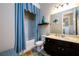 Bathroom with walk in shower, blue curtains and dark wood cabinet at 411 Ridgeway Ln, Canton, GA 30114