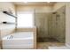 Bathroom featuring a luxurious soaking tub and glass-enclosed shower with elegant tile work at 411 Ridgeway Ln, Canton, GA 30114
