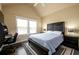 Bedroom featuring a comfortable queen bed and a built-in desk in front of a sunny window at 411 Ridgeway Ln, Canton, GA 30114