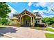 Exterior view of the community clubhouse with stone accents, a covered entrance, and beautiful landscaping at 411 Ridgeway Ln, Canton, GA 30114