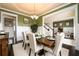 Formal dining room with coffered ceilings, decorative lighting, and seating for six at 411 Ridgeway Ln, Canton, GA 30114