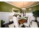 Elegant dining room with wainscoting, stylish chairs, and a dark wood table set for a meal at 411 Ridgeway Ln, Canton, GA 30114