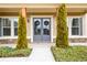 Up close shot of the home's entryway, featuring a double door design and manicured shrubbery at 411 Ridgeway Ln, Canton, GA 30114