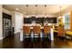 Modern kitchen with stainless steel appliances, dark cabinets, and a granite-topped island at 411 Ridgeway Ln, Canton, GA 30114