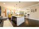 Open-concept kitchen with dark wood floors, an island, and adjacent dining area and living room at 411 Ridgeway Ln, Canton, GA 30114