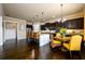 Open concept kitchen with dark wood cabinets, granite countertops, island and eat in breakfast area at 411 Ridgeway Ln, Canton, GA 30114