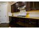 Close up of kitchen with granite countertops, dark cabinets and stainless venthood at 411 Ridgeway Ln, Canton, GA 30114