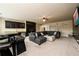A spacious living room featuring a large sectional sofa, wet bar, and accent decor at 411 Ridgeway Ln, Canton, GA 30114