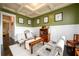 The green living room features a coffered ceiling and white wainscoting at 411 Ridgeway Ln, Canton, GA 30114