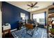 Home office with dark blue walls, a computer desk, and a patterned blue rug at 411 Ridgeway Ln, Canton, GA 30114