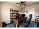 Well-lit home office featuring a computer desk, shelving, and a comfortable office chair at 411 Ridgeway Ln, Canton, GA 30114