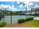 Community tennis court with new surface, lighting and fencing, surrounded by green landscape at 411 Ridgeway Ln, Canton, GA 30114