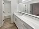 Bathroom featuring a white vanity with marble countertop and oversized mirror at 4409 Idlewood Ln, Tucker, GA 30084