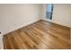 Bright bedroom showcasing wood-look floors and ample natural light from the window at 4409 Idlewood Ln, Tucker, GA 30084