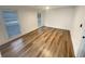 Bright bedroom with wood plank floors, two windows with blinds, and updated white walls and trim at 4409 Idlewood Ln, Tucker, GA 30084