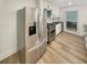 Bright kitchen with stainless steel appliances, white cabinets, and wood-look floors at 4409 Idlewood Ln, Tucker, GA 30084