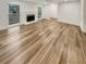 Open-concept living room featuring wood-look floors and a classic fireplace at 4409 Idlewood Ln, Tucker, GA 30084
