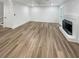 Spacious living area with a white fireplace and wood-look floors at 4409 Idlewood Ln, Tucker, GA 30084