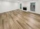 An empty living room featuring a fireplace, large windows and light wood flooring at 4409 Idlewood Ln, Tucker, GA 30084