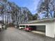 Carport parking area featuring multiple parking spaces with a row of tall trees in the background at 4409 Idlewood Ln, Tucker, GA 30084