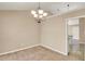 Dining room showcasing chandelier, neutral carpet, and entrance to kitchen at 4260 Platinum Ct, Hoschton, GA 30548