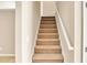 Carpeted staircase with white railing leading to upper level at 4260 Platinum Ct, Hoschton, GA 30548