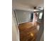 Open living room with hardwood floors, ceiling fan, and an open door leading to the outside at 571 Formwalt Sw St # 7, Atlanta, GA 30312