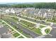 Aerial view of a community showcasing manicured lawns, a community garden, and stylish homes at 578 Brashy Street, Woodstock, GA 30188