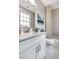 Clean bathroom featuring gray tile, a marble countertop, and a shower with patterned curtain at 578 Brashy Street, Woodstock, GA 30188